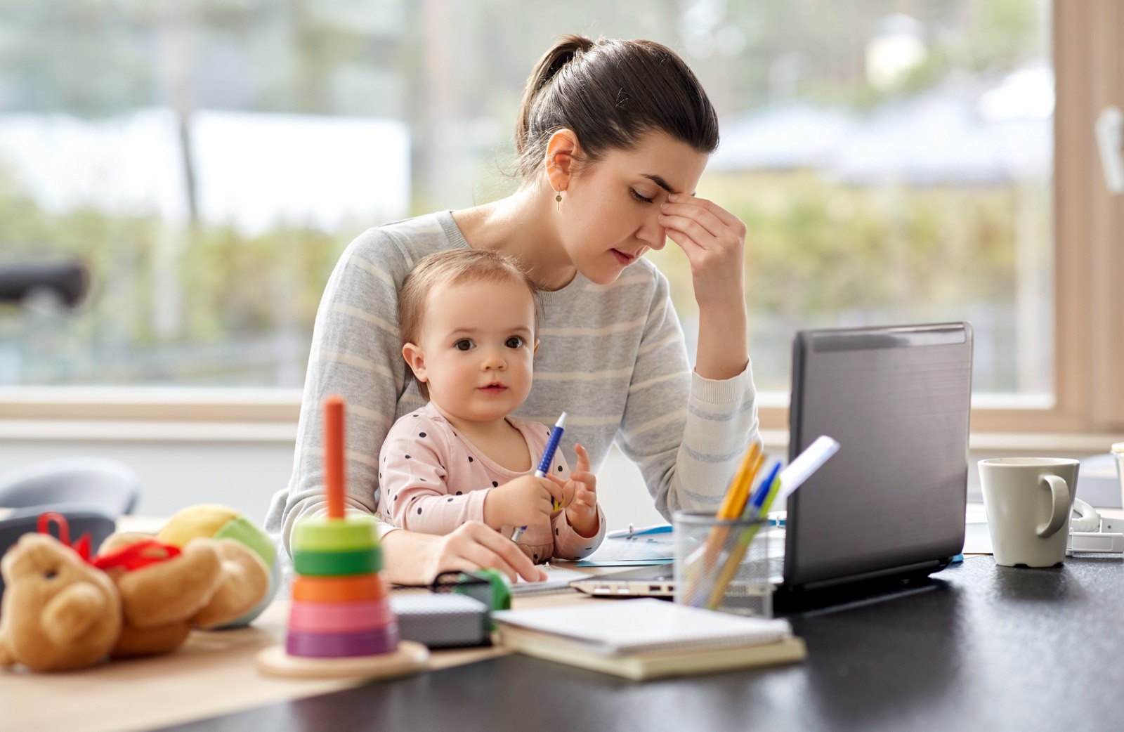 A parent organizing tax paperwork at a home desk