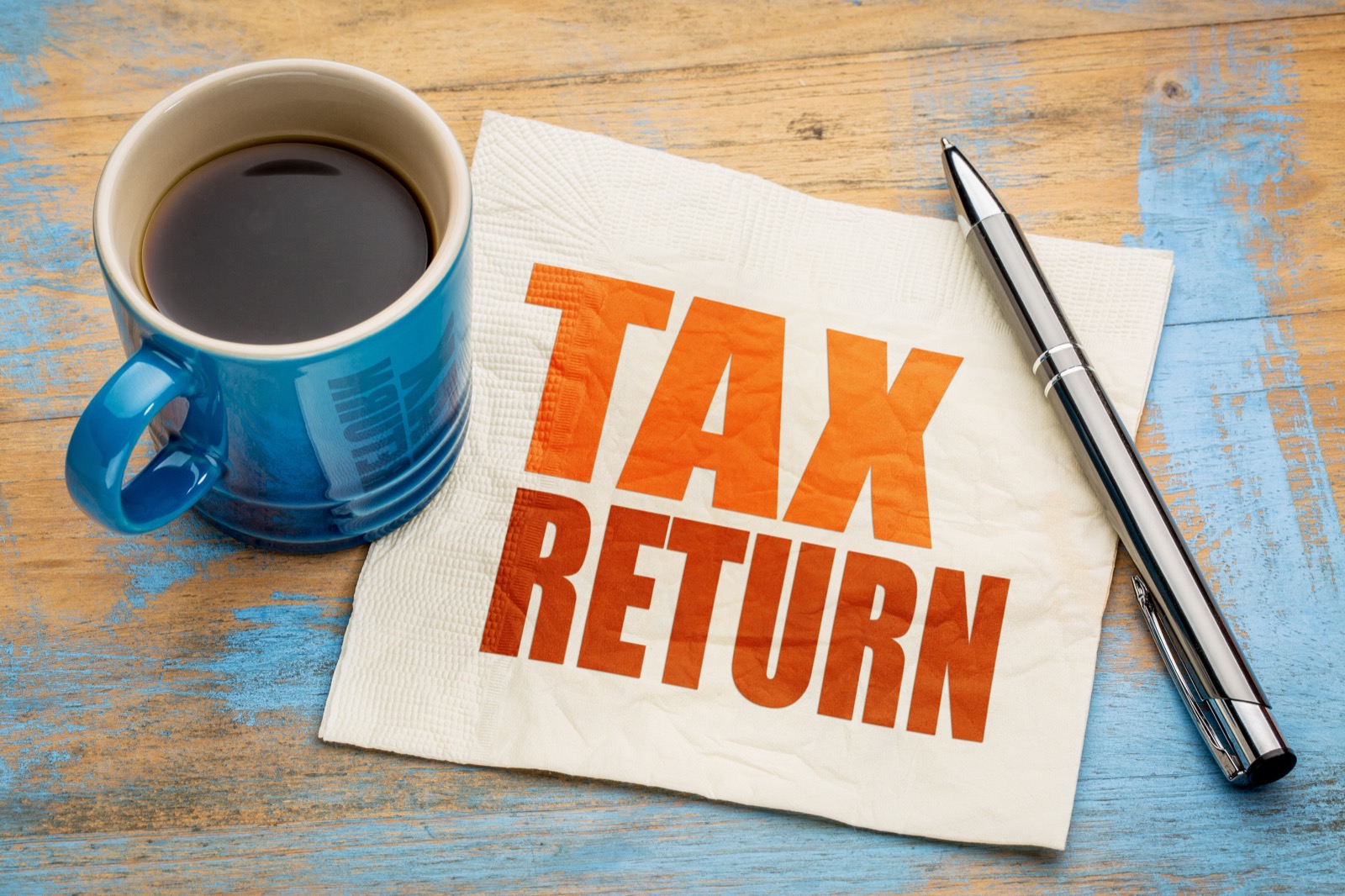 Tax return planning notes beside a calculator